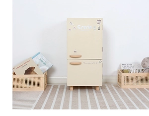 Close-up of a Nordic style wooden toy refrigerator with cream finish and wood handles