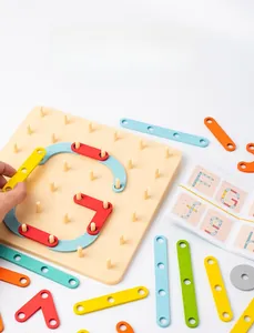Close-up of wooden pegboard with colorful geometric pieces for creative educational play