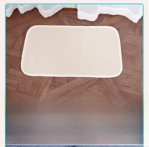 Detail of cream Montessori work rug with woven texture on wooden floor for classroom