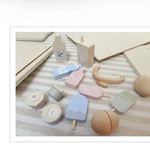 Detailed top view of wooden play food set with milk, ice cream and fruit cups in macaron colors
