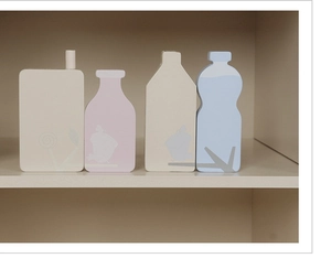Macro detail of Nordic wooden toy kitchen milk bottles with minimalist bird illustrations