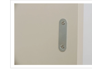 Close-up of a brushed metal flat connector plate secured with screws on a wooden board