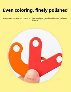 Close-up of smooth wooden puzzle piece with rounded edges and uniform red painting