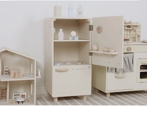Detail view of the wooden play refrigerator interior with miniature food accessories