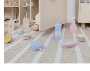 Detail of wooden play food set with assorted beverage bottles and ice pops in macaron tones