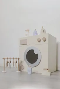 Detail of wooden play washing machine set with hangers and miniature accessories