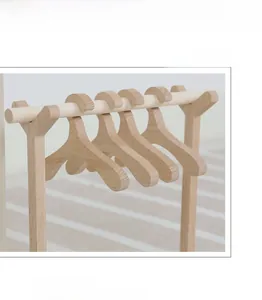 Detail of smooth beech wood mini hangers and rack showing the natural wood texture