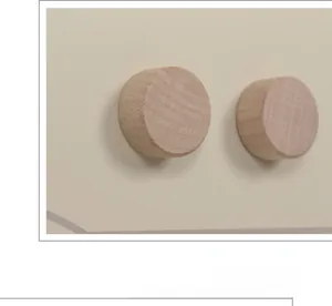 Detail of sturdy wooden knobs on play kitchen fridge with natural wood grain texture