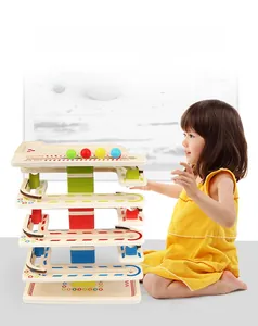 Detail of wooden marble run toy with colorful slides and balls for toddler interaction