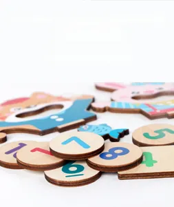Detail of laser-engraved wooden math puzzle blocks with numbers and cute animal shapes