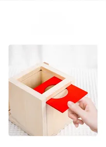 Detail of wooden Montessori 4-in-1 activity cube with removable red game board design