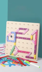 Close-up of wooden geometric pegboard toy with colorful elastic bands forming a fish shape