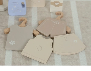 Detailed view of Nordic wooden laundry playset with mini clothes and small hangers