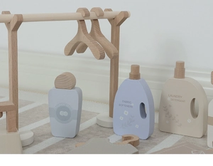Detail of wooden laundry toy set with hangers and laundry detergent bottles