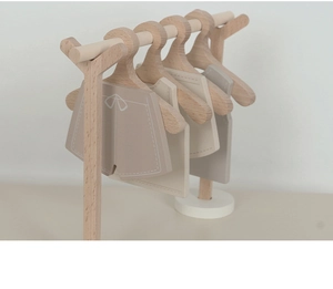 Close-up of wooden mini clothes rack and hangers with Nordic minimalist design for kids