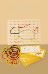 Detail of wooden geoboard set with colorful rubber bands and educational cards