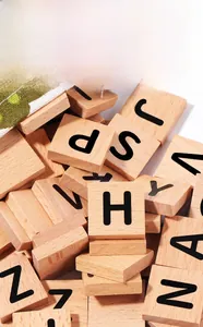 Detailed macro view of natural beech wood alphabet blocks with clear letter engravings