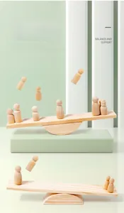Macro view of rainbow wooden peg dolls showing natural wood grain and balancing support