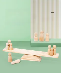 Detailed macro view of wooden rainbow people figures on a balancing scale toy set