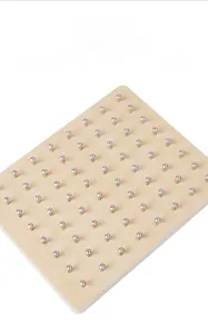Close-up of durable aluminum nails arranged on a Montessori wooden geometric geoboard
