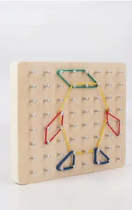 Detailed close-up of a wooden geoboard with elastic bands forming a penguin shape