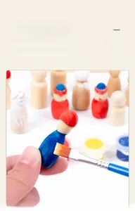 Detail of hand painting a DIY wooden peg doll with blue paint and brush for kids