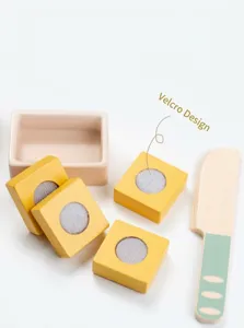 Detail of wooden play food set with velcro design and a toy knife for kids