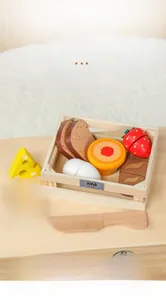 Detail of wooden play food set including toast, egg and steak in a portable basket