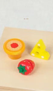 Detail of smoothly polished wooden play food toys including burger, bread and strawberry