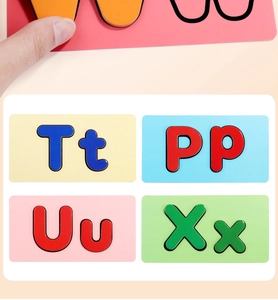 Close-up of magnetic English letter tiles showing Tt, Pp, Uu, Xx for alphabet learning