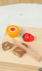 Detail of wooden play food set showing strawberry with velcro and toy knife