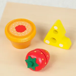 Polished wooden play food set featuring toy strawberry, cake, and cheese for kids