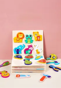 Detail of wooden geometric puzzle pieces featuring colorful animals and fruits for kids