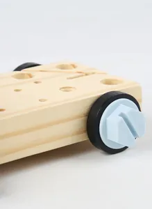 Macro detail of wooden toy workbench with sturdy holes and blue plastic screw bolts
