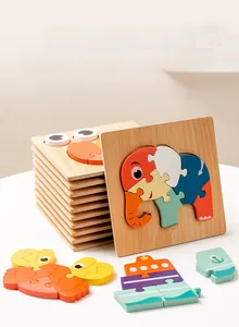 Close-up of thick wooden puzzle boards featuring colorful animal and boat shapes