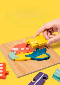 Close-up of child placing colorful wooden helicopter puzzle blocks on natural wood base