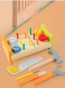Detail of wooden toy workbench set with hammer, saw, wrench and colorful nuts for kids
