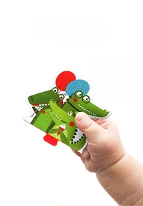 Toddler hand holding a thick crocodile puzzle piece for easy grip and early counting learning