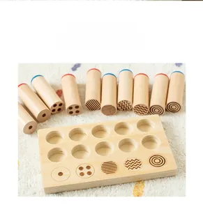 Macro detail of Montessori wooden sensory cylinders showing geometric patterns and texture
