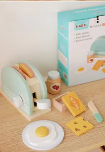 Macro view of mint green wooden toaster toy set with play food and butter accessories