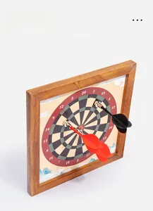 Close-up of magnetic dartboard with wooden frame and red and black safety darts