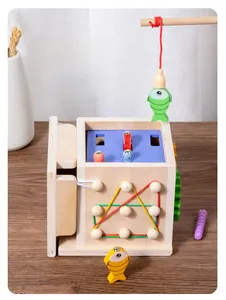 Detail of wooden busy box featuring magnetic fishing game and geometric shape board