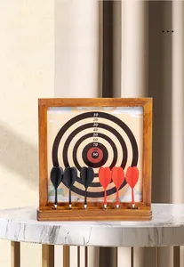 Close-up of magnetic dartboard set with wooden frame and scores on marble surface