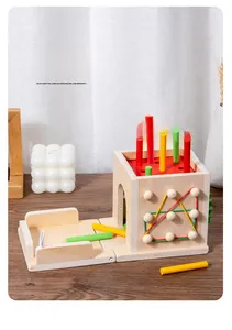 Detail of wooden sensory game box for toddlers featuring colorful sticks and elastic bands