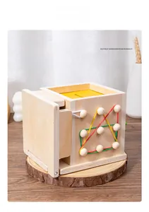 Detail of wooden Montessori toy with colorful rubber bands on a geometric pegboard