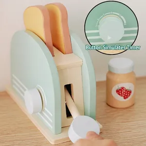 Wooden toy toaster set in pale green with two slices of bread for imaginative kitchen play