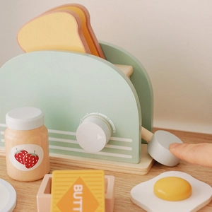 Kids wooden toaster toy set in pastel green with sliced bread, butter and strawberry jam