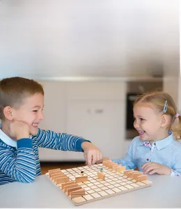 Children playing wooden logic board game for cognitive skill development and interaction