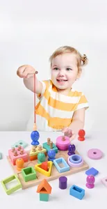 Close-up of a girl playing with a 3-in-1 magnetic wooden fishing and shape sorter toy set