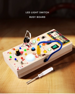 Macro shot of Montessori wooden busy board with LED lights and festive Christmas toggles
